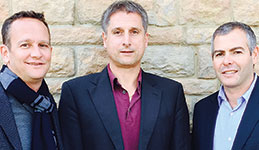 Jürgen Müller, KVG vice president of sales, standing between Actum Group directors Kevin Klaff (left) and Greg Barron (right).